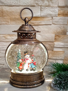 Svietiaci hrajúci vianočný LED lampáš snehuliak 26 cm